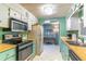 Well-equipped kitchen with light green cabinets and wood countertops at 151 E Plantation Blvd, Lake Mary, FL 32746