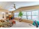 Sunlit living room showcasing a comfortable seating arrangement and home office at 151 E Plantation Blvd, Lake Mary, FL 32746
