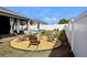 Relaxing backyard with firepit and seating area at 15267 Aquarius Way, Mascotte, FL 34753