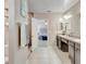 Main bathroom with double vanity, shower and access to the bedroom at 15267 Aquarius Way, Mascotte, FL 34753