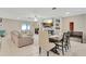Casual dining area adjacent to living room and kitchen at 15267 Aquarius Way, Mascotte, FL 34753