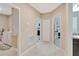 Clean and bright hallway with access to laundry and bedrooms at 15267 Aquarius Way, Mascotte, FL 34753