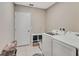 Laundry room with washer, dryer, and storage at 15267 Aquarius Way, Mascotte, FL 34753