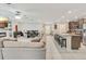 Open living space with a fireplace and large sectional sofa at 15267 Aquarius Way, Mascotte, FL 34753