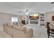 Comfortable living room featuring a fireplace and a large TV at 15267 Aquarius Way, Mascotte, FL 34753