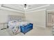 Spacious main bedroom with a comfy bed and blue bench at 15267 Aquarius Way, Mascotte, FL 34753