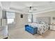 Large main bedroom with plush carpet and ceiling fan at 15267 Aquarius Way, Mascotte, FL 34753