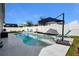 Inviting kidney shaped pool with lounge chairs and umbrellas at 15267 Aquarius Way, Mascotte, FL 34753