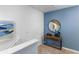 Upstairs hallway featuring a stylish console table and a large circular mirror at 1535 Isleta Loop, Kissimmee, FL 34741