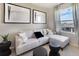 Cozy sitting area with sectional sofa, window, and wood-framed art at 1537 Isleta Loop, Kissimmee, FL 34741