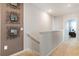 Upstairs hallway with wall-mounted mirrors and carpeting at 1537 Isleta Loop, Kissimmee, FL 34741