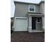 Charming two-story home featuring a one car garage and a neatly bricked driveway at 1541 Isleta Loop, Kissimmee, FL 34741