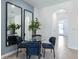 Small dining area with glass table and blue chairs at 1543 Isleta Loop, Kissimmee, FL 34741