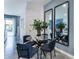 Modern dining area with glass table and four blue chairs at 1543 Isleta Loop, Kissimmee, FL 34741