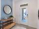 Bright and airy entryway with a stylish console table and mirror at 1543 Isleta Loop, Kissimmee, FL 34741