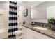 Bathroom with granite countertop, white cabinets, and a shower/tub combo at 1545 Isleta Loop, Kissimmee, FL 34741