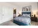 Well-lit bedroom with a blue bed frame and en-suite bathroom at 1545 Isleta Loop, Kissimmee, FL 34741