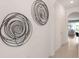 Hallway with two circular metal wall sculptures at 1545 Isleta Loop, Kissimmee, FL 34741