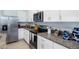 Modern kitchen with white cabinets, granite countertops, and stainless steel appliances at 1545 Isleta Loop, Kissimmee, FL 34741