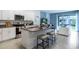 Open concept kitchen with island, stainless steel appliances, and white cabinets at 1545 Isleta Loop, Kissimmee, FL 34741
