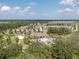 Aerial view of the community amenities including the pool, clubhouse, and playground surrounded by mature trees at 1882 Rustic Falls Dr, Kissimmee, FL 34744