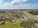 Wide aerial view of the community showing amenities, parking, roads, and multiple residences at 1882 Rustic Falls Dr, Kissimmee, FL 34744