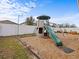 Backyard featuring a play structure and ample space for outdoor activities at 1882 Rustic Falls Dr, Kissimmee, FL 34744