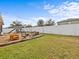 Spacious backyard featuring a playset, patio seating, and a well-maintained lawn perfect for outdoor activities at 1882 Rustic Falls Dr, Kissimmee, FL 34744