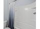 Bathroom featuring a shower with a curtain, a toilet, and tiled floors at 1882 Rustic Falls Dr, Kissimmee, FL 34744