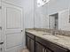 Bathroom featuring a double vanity with granite countertops, tiled floor, and a door to the toilet at 1882 Rustic Falls Dr, Kissimmee, FL 34744