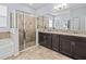 Bathroom featuring a double vanity, granite countertop, tile floor, and a glass shower at 1882 Rustic Falls Dr, Kissimmee, FL 34744