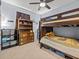 Bedroom with bunk beds, carpet flooring, storage shelves, and overhead lighting at 1882 Rustic Falls Dr, Kissimmee, FL 34744