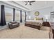 Relaxing main bedroom featuring a tray ceiling, carpet flooring, and lots of natural light at 1882 Rustic Falls Dr, Kissimmee, FL 34744