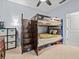 Bedroom featuring a bunk bed, storage cube organizer, ceiling fan, and carpeted floors at 1882 Rustic Falls Dr, Kissimmee, FL 34744