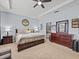 A light filled bedroom with a tray ceiling, neutral carpet, and en-suite bathroom access at 1882 Rustic Falls Dr, Kissimmee, FL 34744