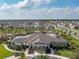 Community clubhouse featuring a pool, lounging area, and well-maintained landscaping with ample parking at 1882 Rustic Falls Dr, Kissimmee, FL 34744