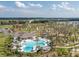 Aerial shot showcasing a large community pool with lounge chairs, shaded areas, and landscaped surroundings at 1882 Rustic Falls Dr, Kissimmee, FL 34744