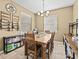 Inviting dining room with rustic wooden table and ample natural light at 1882 Rustic Falls Dr, Kissimmee, FL 34744