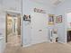 Hallway featuring tile floors, access to other bedrooms, and a small study area at 1882 Rustic Falls Dr, Kissimmee, FL 34744
