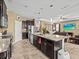 Open kitchen featuring a large island with granite countertops and modern appliances at 1882 Rustic Falls Dr, Kissimmee, FL 34744