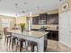 Spacious kitchen featuring granite countertops and a central island with barstool seating at 1882 Rustic Falls Dr, Kissimmee, FL 34744