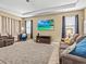 Living room showcasing a large-screen TV, neutral walls, and comfortable furniture at 1882 Rustic Falls Dr, Kissimmee, FL 34744
