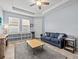 Living room with large windows, a sofa, and tile flooring with carpet at 1882 Rustic Falls Dr, Kissimmee, FL 34744