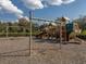 Playground featuring various play structures, swings, slides and climbing areas within a fenced area at 1882 Rustic Falls Dr, Kissimmee, FL 34744