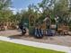 Community playground featuring multiple slides, climbing structures, and play areas for enjoyment at 1882 Rustic Falls Dr, Kissimmee, FL 34744