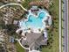 Aerial view of a community pool area with ample seating, cabanas, and beautifully landscaped surroundings at 1882 Rustic Falls Dr, Kissimmee, FL 34744