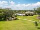 Scenic aerial view of the community pool and clubhouse with beautifully landscaped grounds and walking paths at 1882 Rustic Falls Dr, Kissimmee, FL 34744