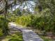Tranquil walking path winding through lush greenery, creating a serene and inviting outdoor experience at 1882 Rustic Falls Dr, Kissimmee, FL 34744
