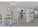 Eat-in kitchen with gray and white cabinets, an island, and a chandelier at 206 Piave St, Haines City, FL 33844