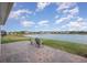 Backyard featuring a serene lake view and a brick patio at 213 Caryota Ct, New Smyrna Beach, FL 32168